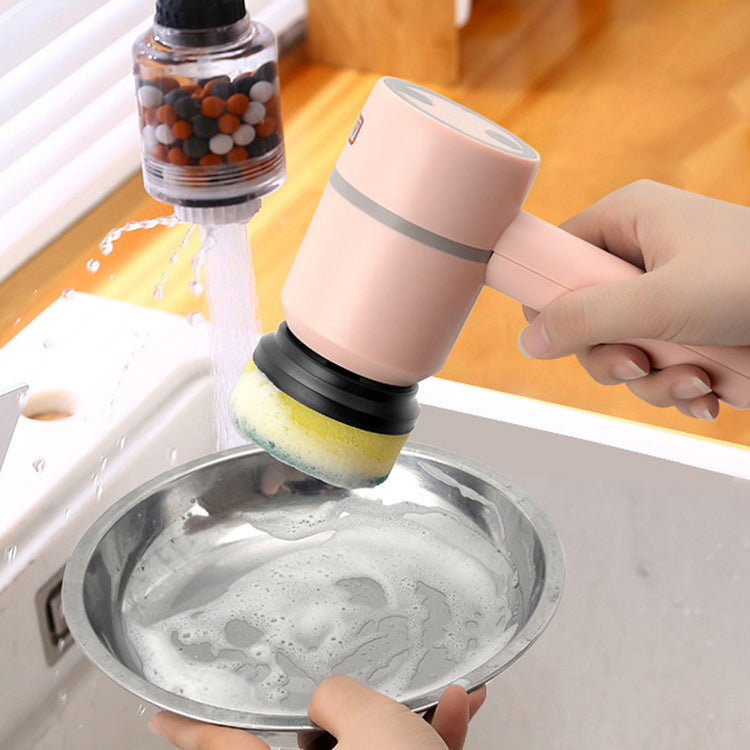 a hand holding a pink sponge over a bowl of water