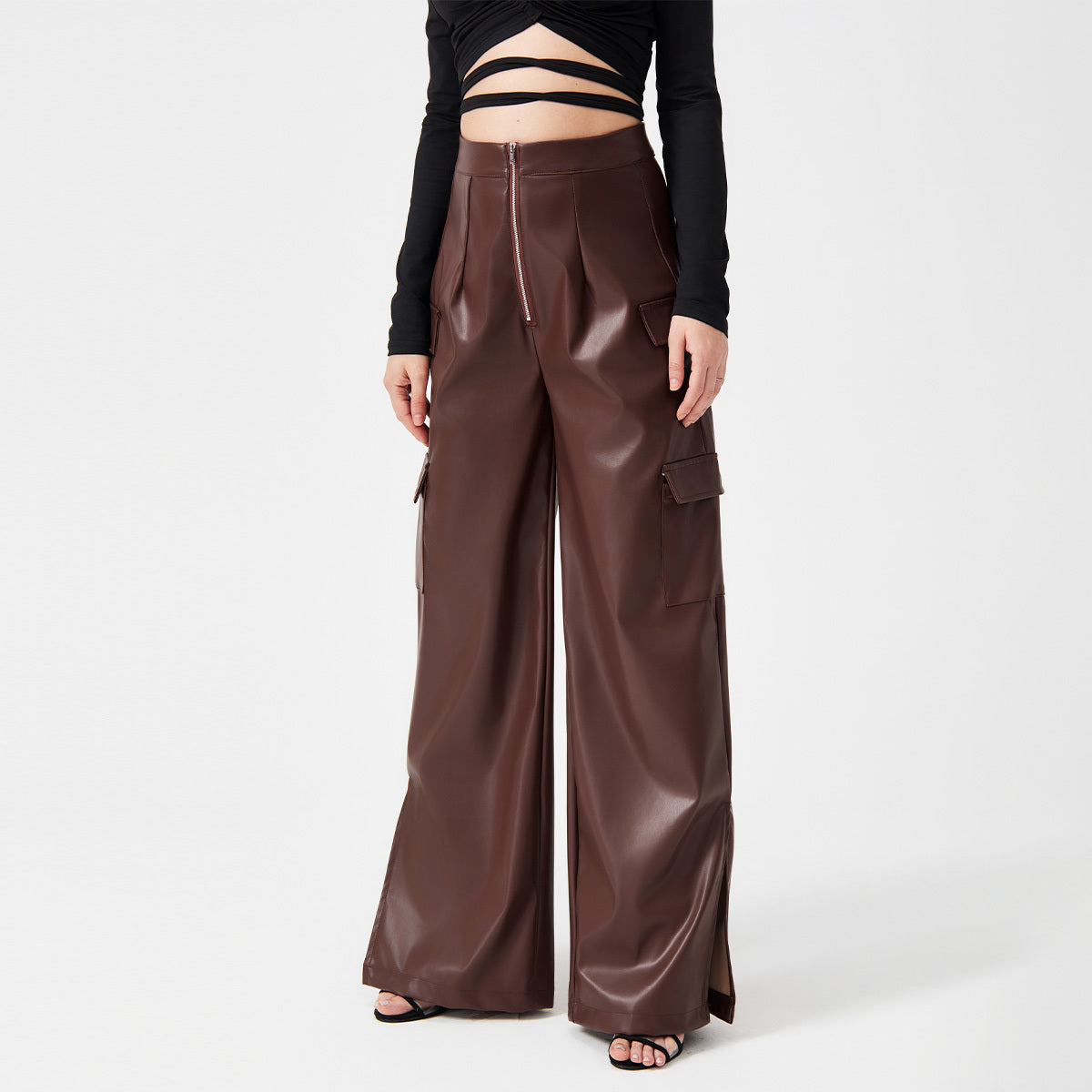 a woman wearing a black top and brown pants
