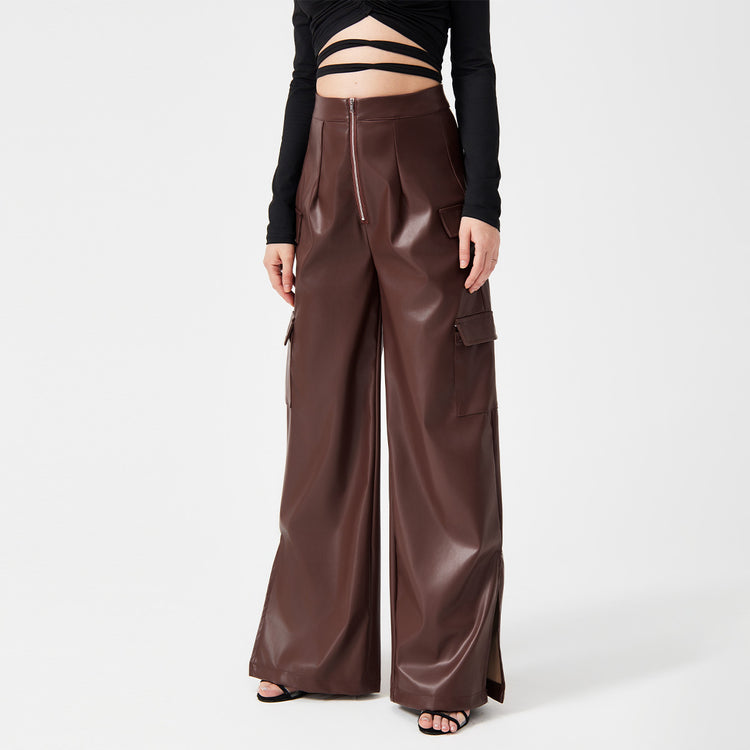 a woman wearing a black top and brown pants