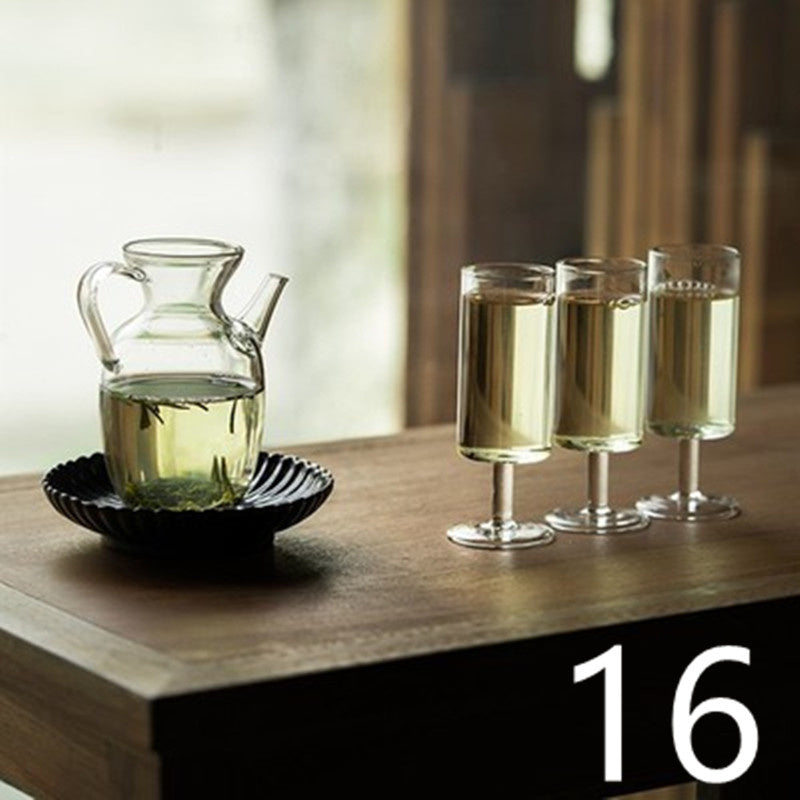 a glass pitcher and glasses of liquid on a table