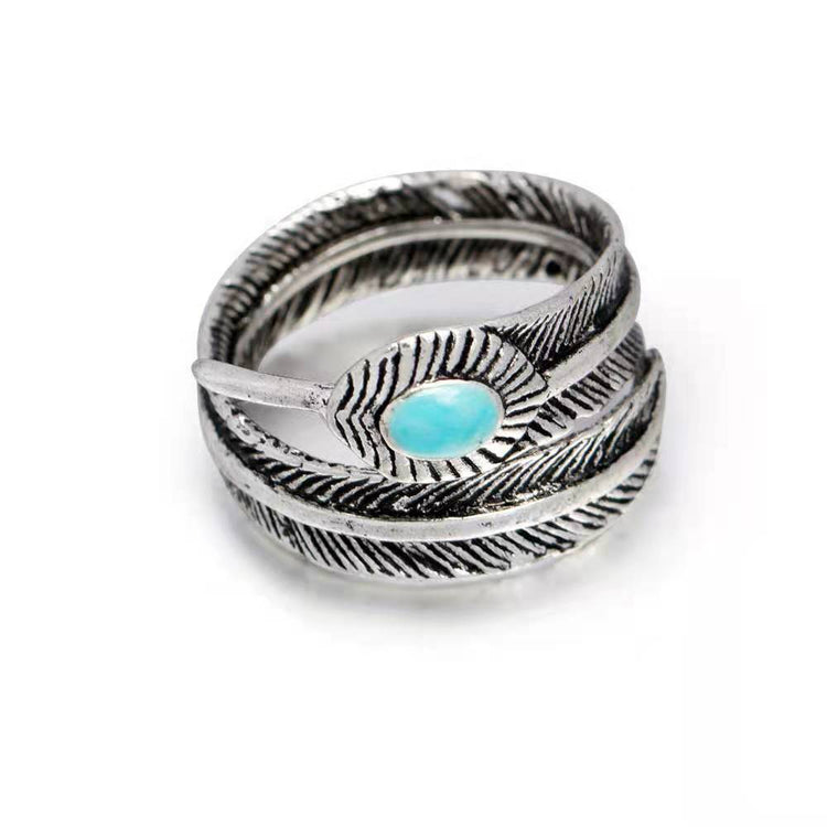 a silver ring with a blue stone