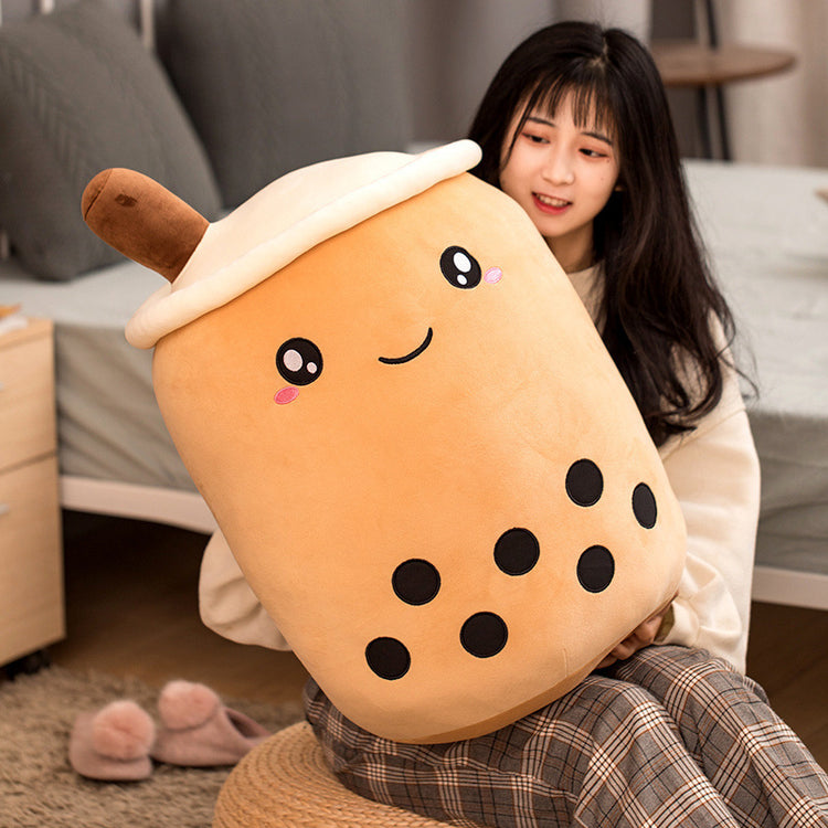 a woman holding a large plush toy