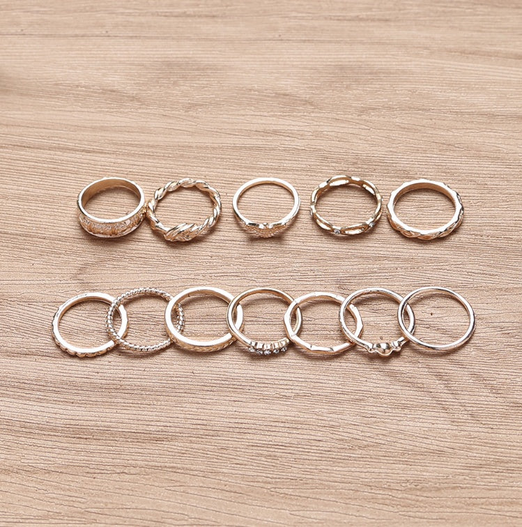a row of gold rings on a wood surface