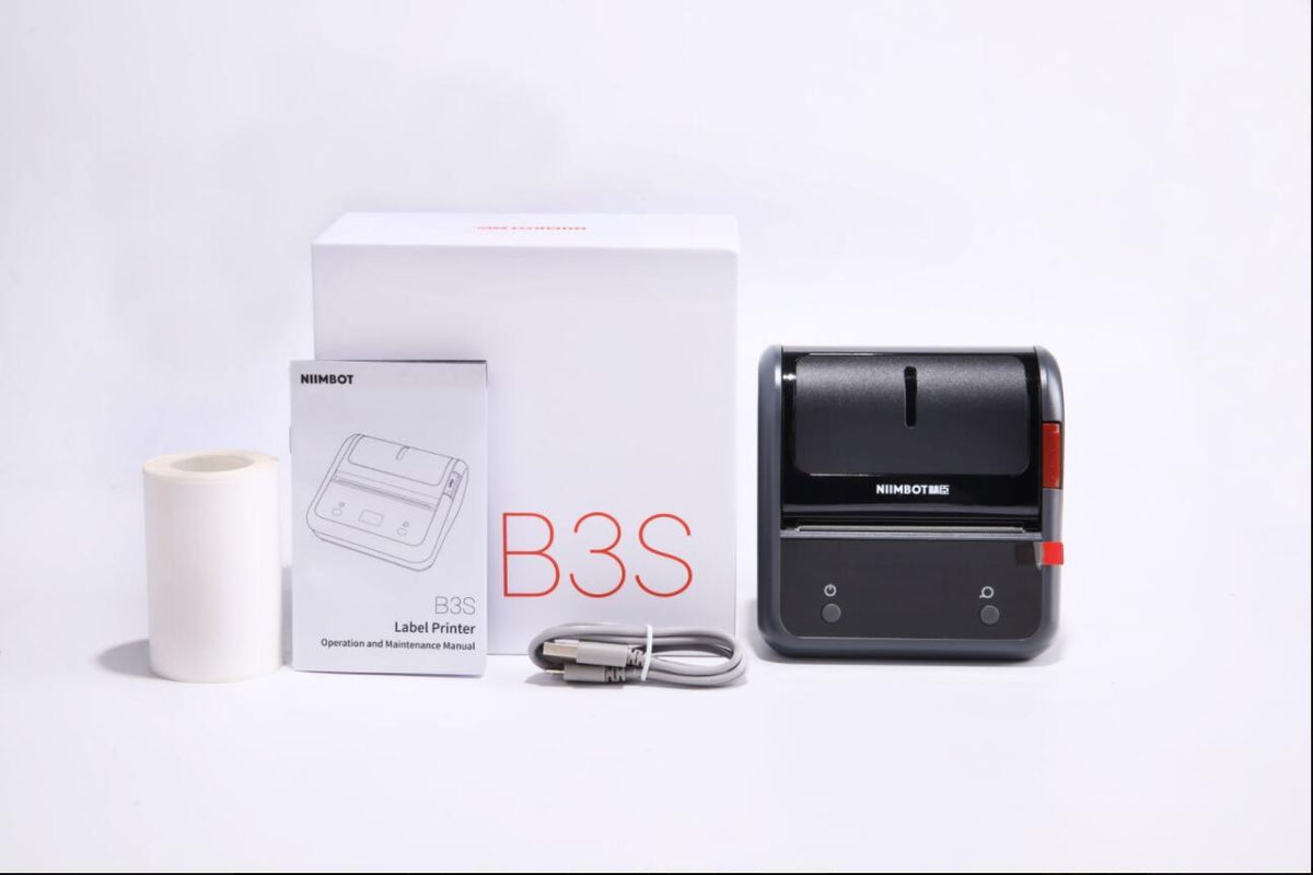 a black label printer and a box