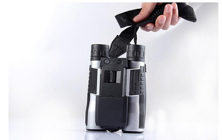 a hand holding a black and grey binoculars