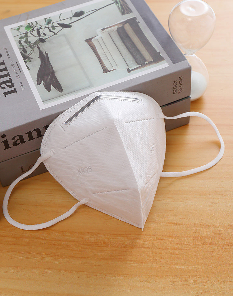 a face mask next to a book