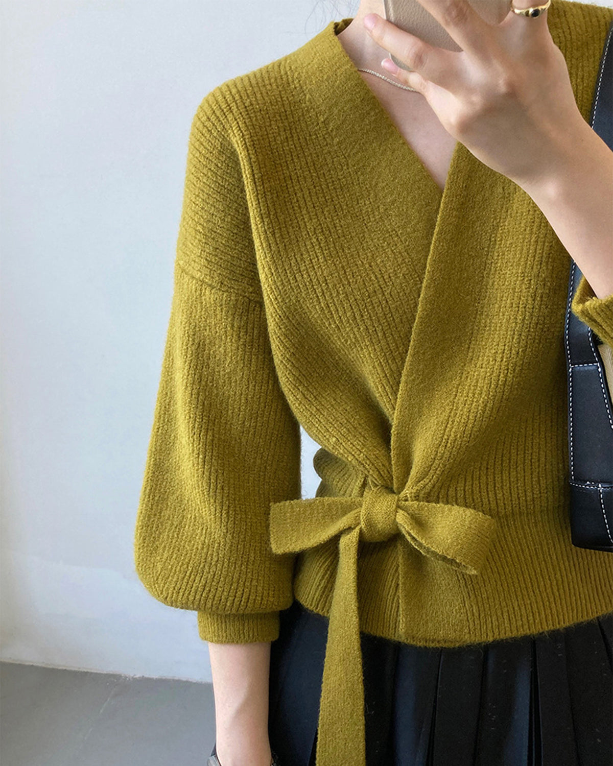 a woman wearing a green sweater