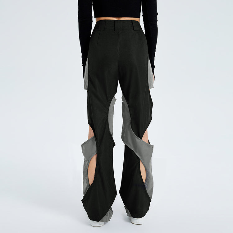 a person wearing black pants with cut out designs