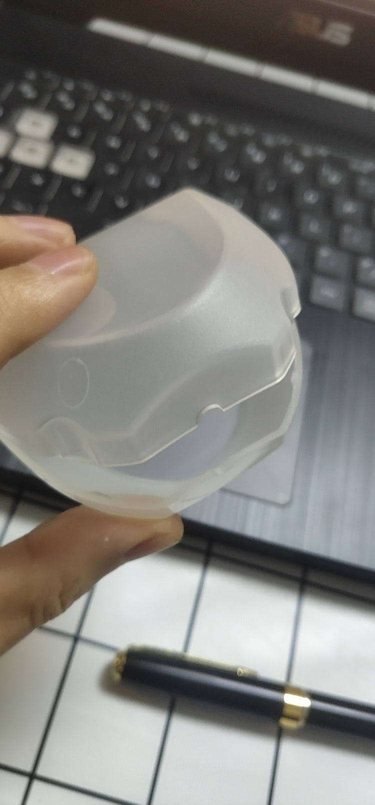 a hand holding a plastic container