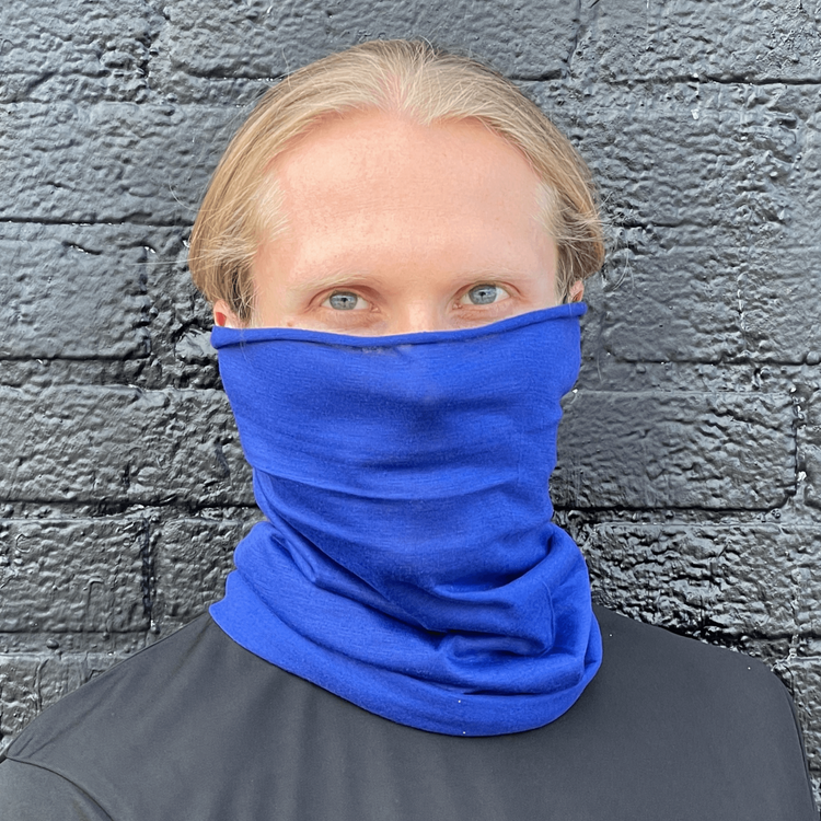 a man wearing a blue scarf over his face