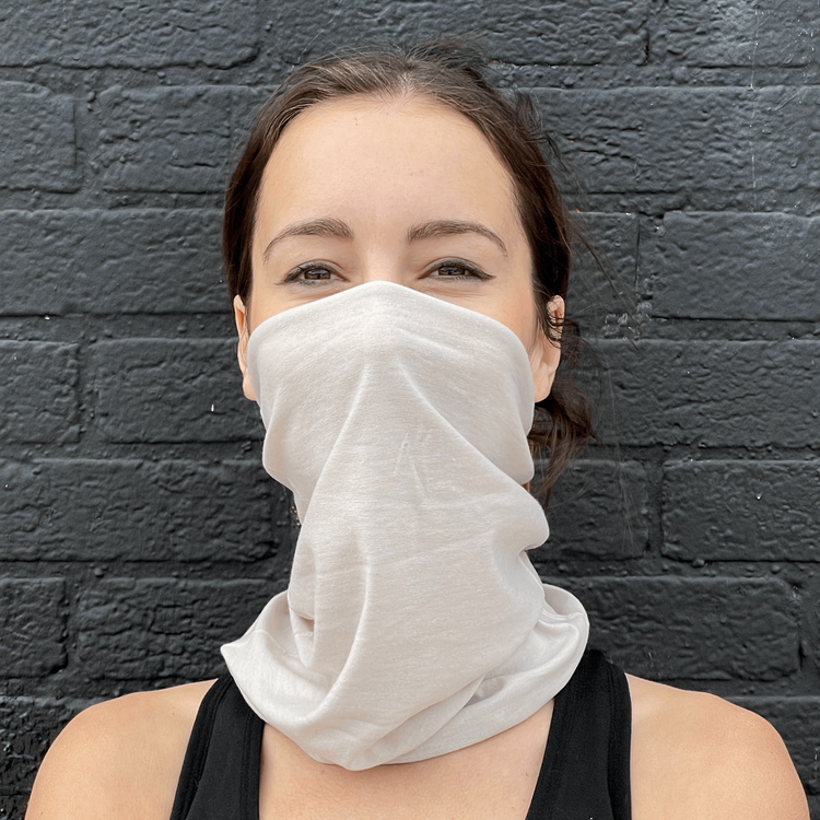 a woman wearing a white scarf over her face