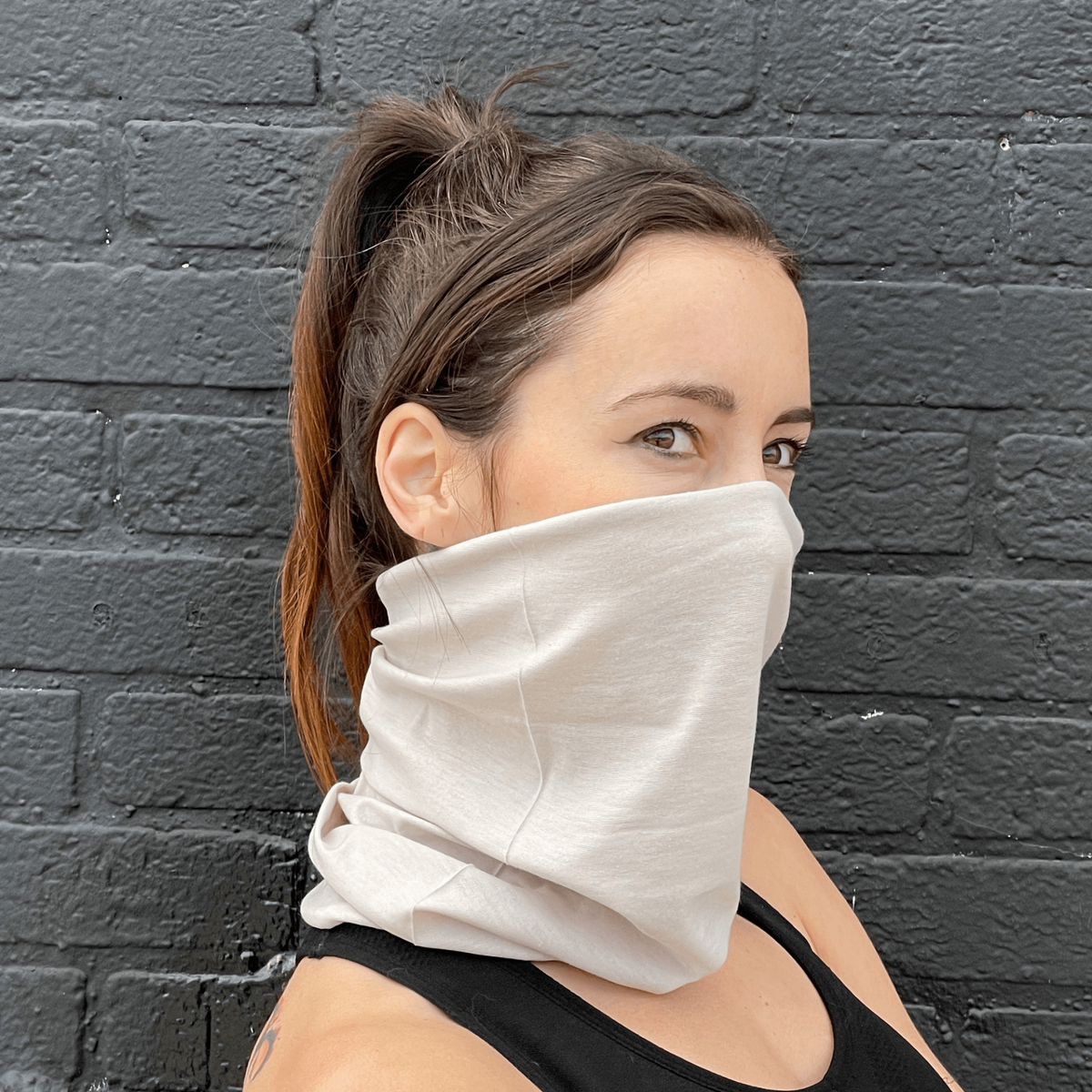 a woman wearing a scarf over her face