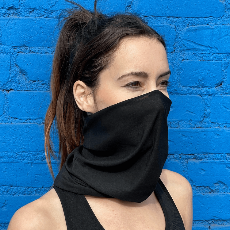 a woman wearing a black scarf over her face