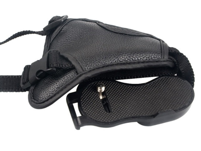 a black camera strap with a small screw