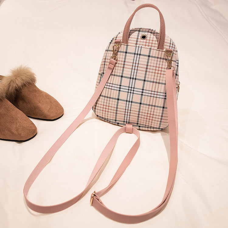 a pink and white plaid backpack and shoes