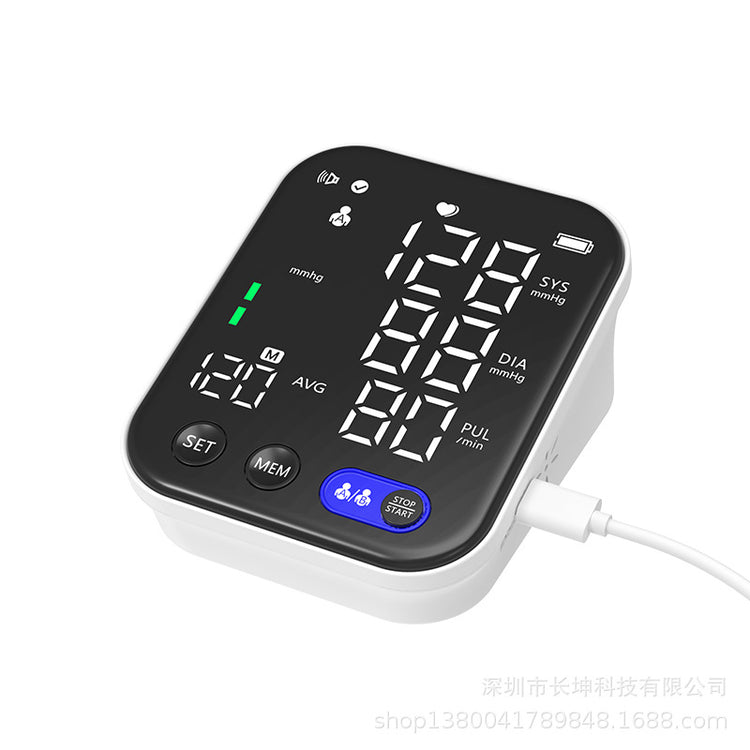 a black and white digital blood pressure monitor