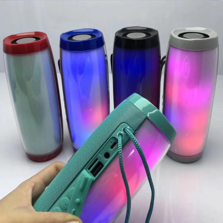 a hand holding a bluetooth speaker