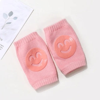a pair of pink socks with smiley faces on them