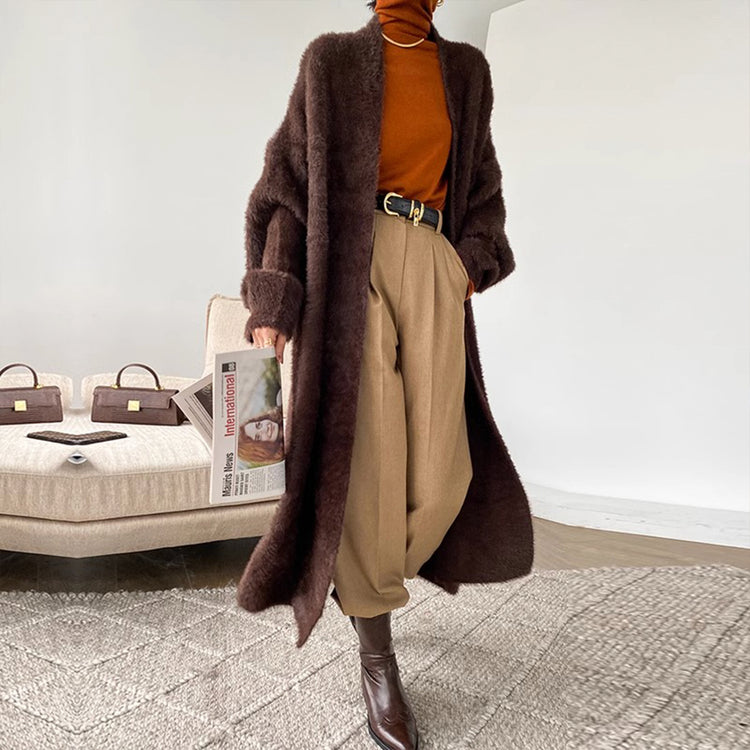 a person wearing a long coat and brown pants