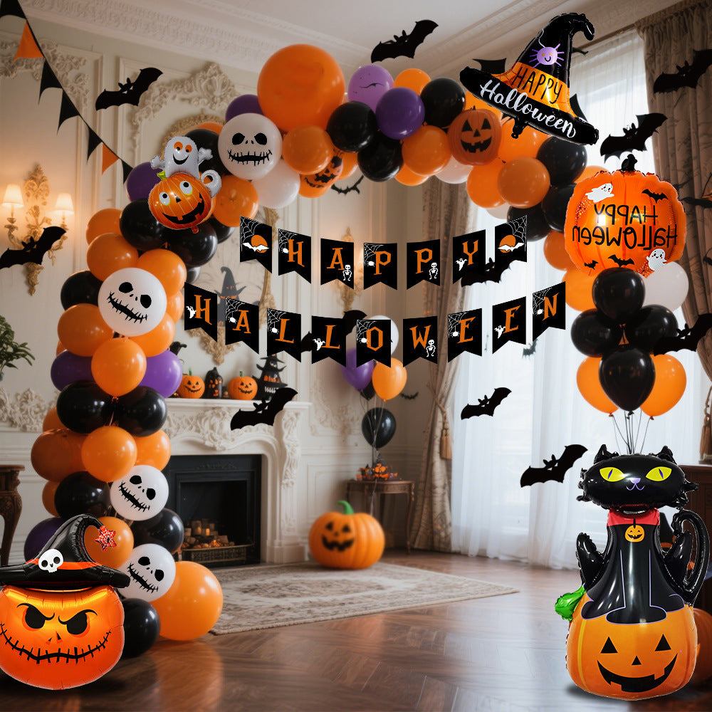 a halloween balloon arch with pumpkins and bats