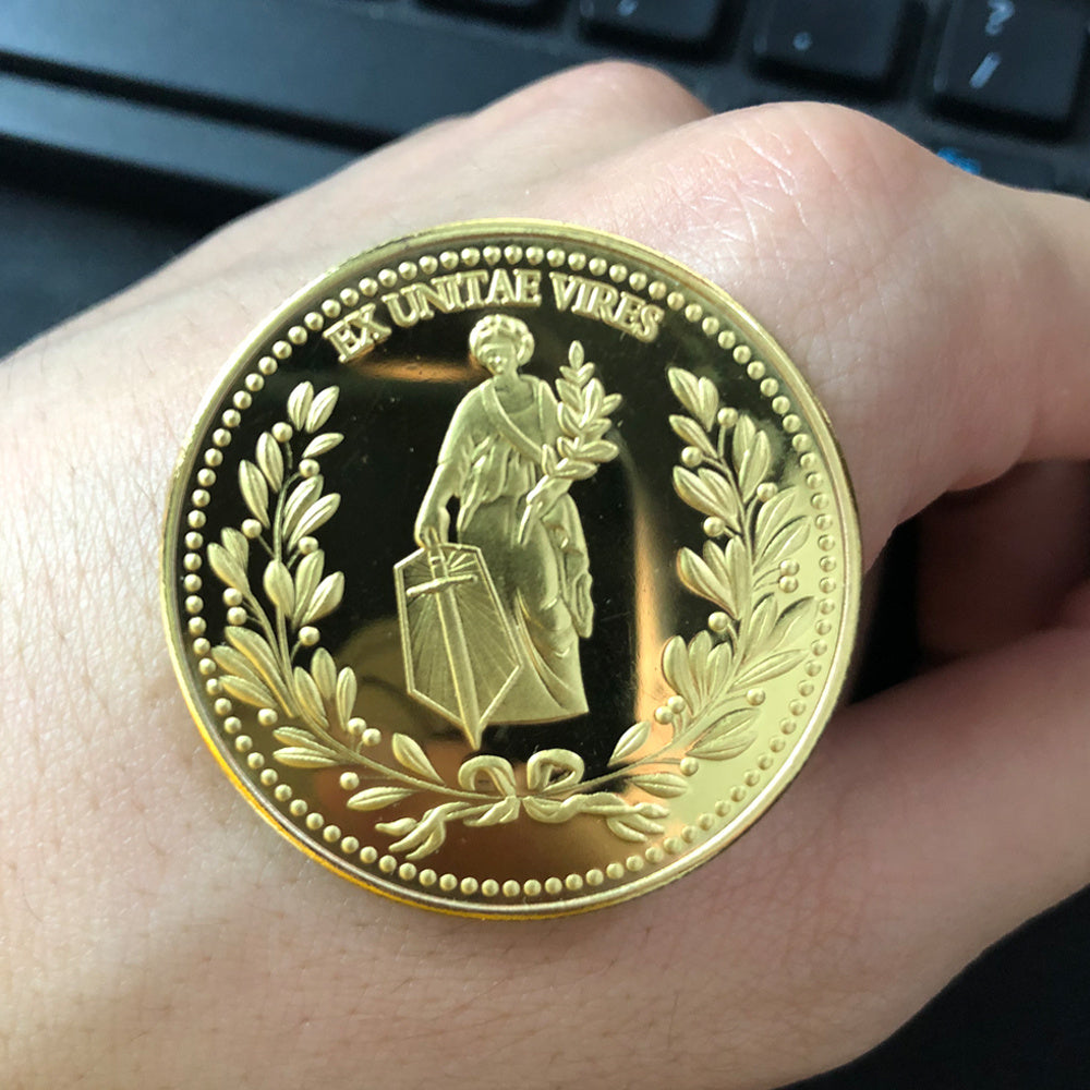 a gold coin on a hand
