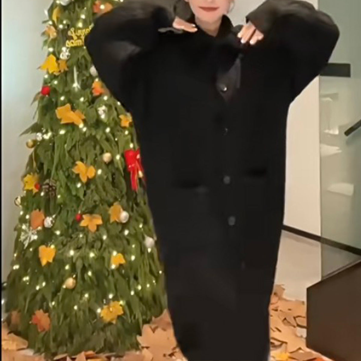 a woman in a long black coat