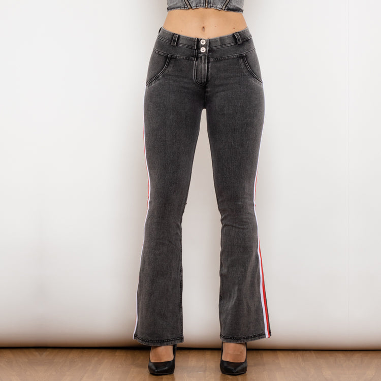 a woman wearing black jeans and high heels