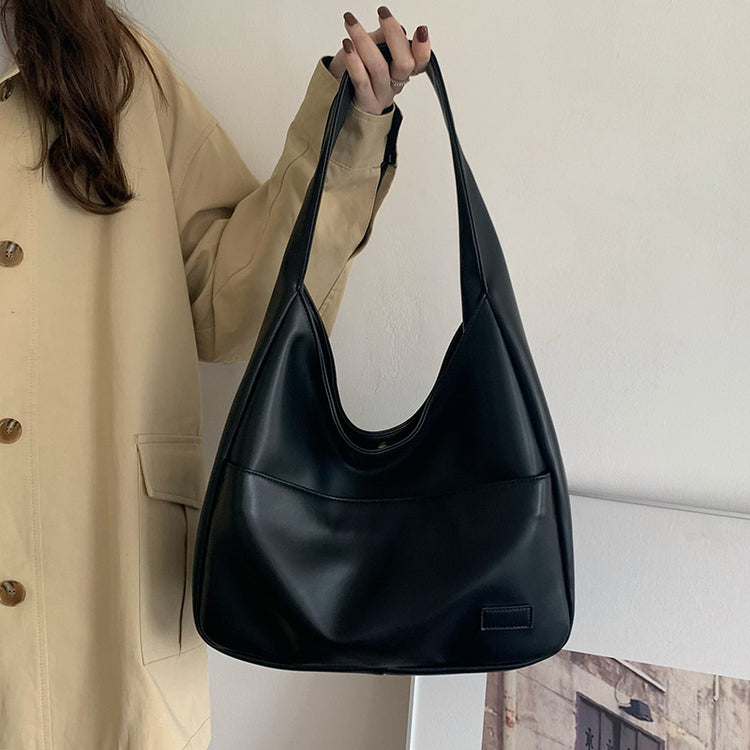 a woman holding a black purse