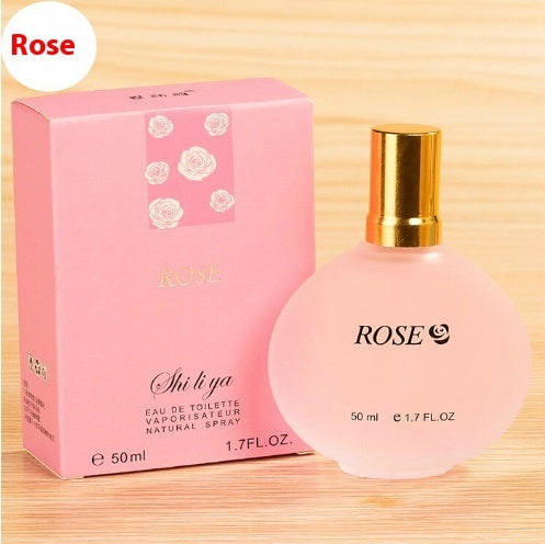 a bottle of perfume in a pink box