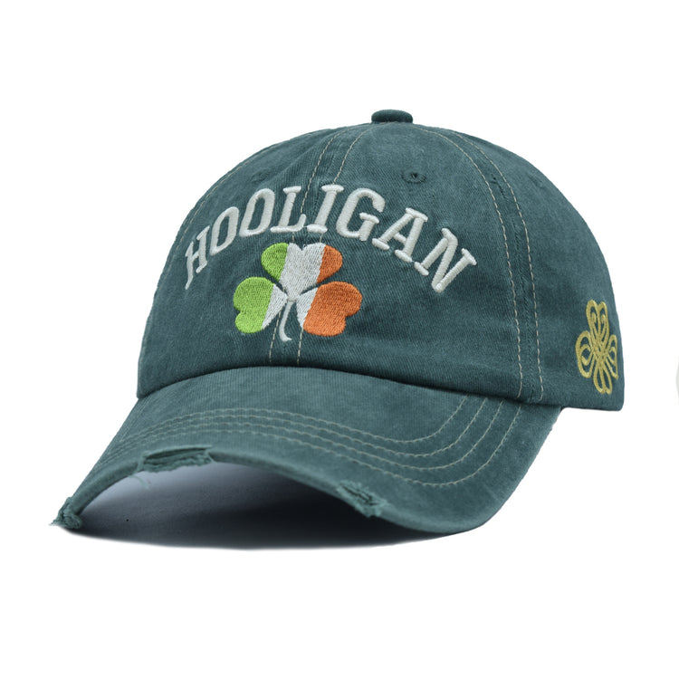 a green hat with a four leaf clover on it
