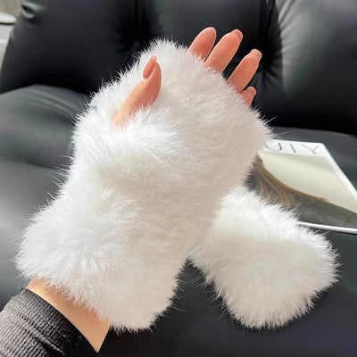 a hand wearing a furry white glove