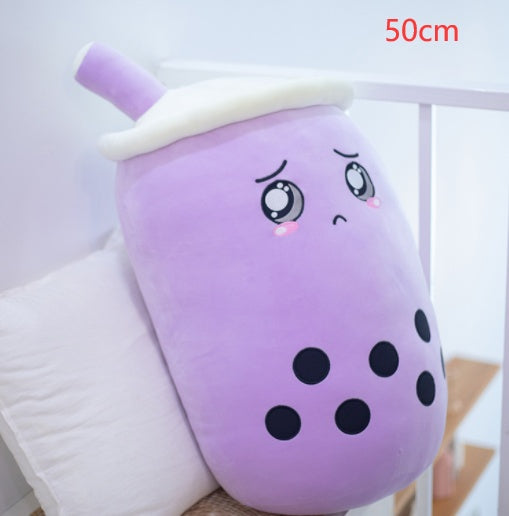 a purple soft toy with a sad face