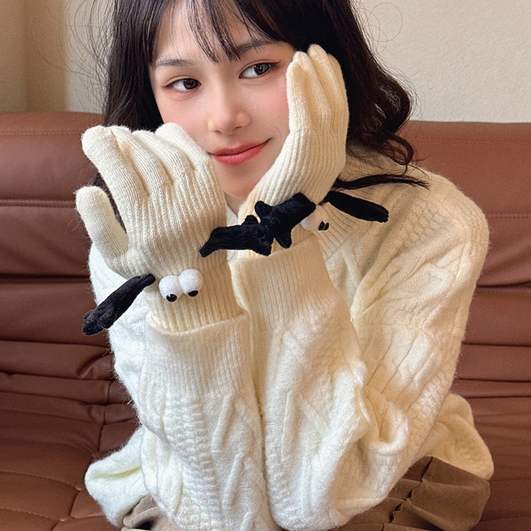 a woman wearing a white sweater and gloves
