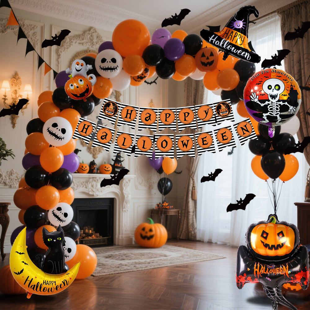 a halloween balloon arch with a banner and pumpkins