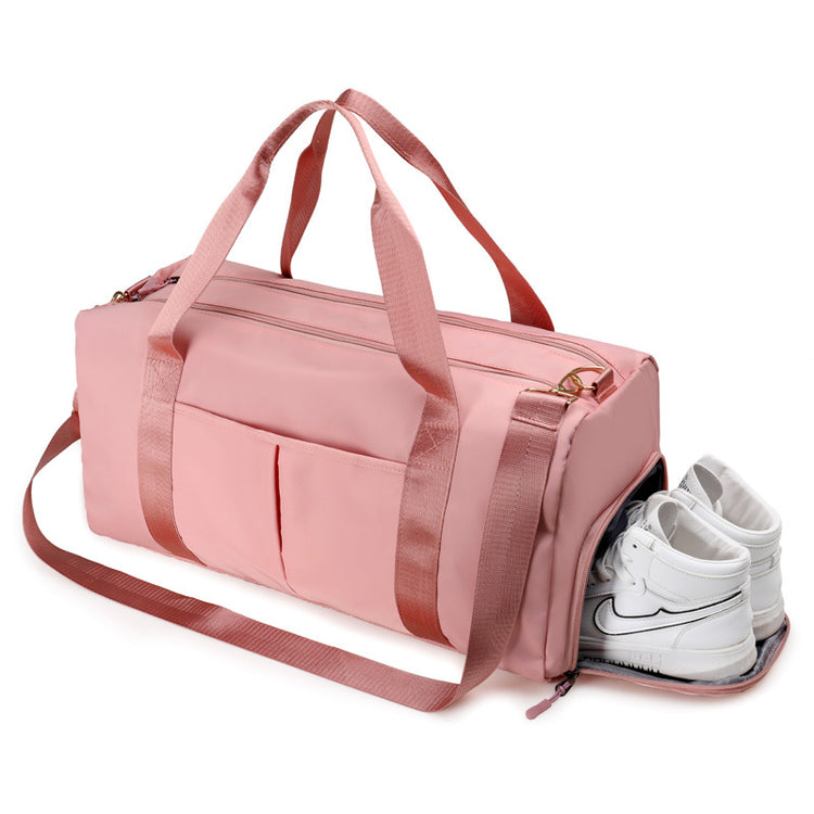 a pink duffel bag with white shoes inside