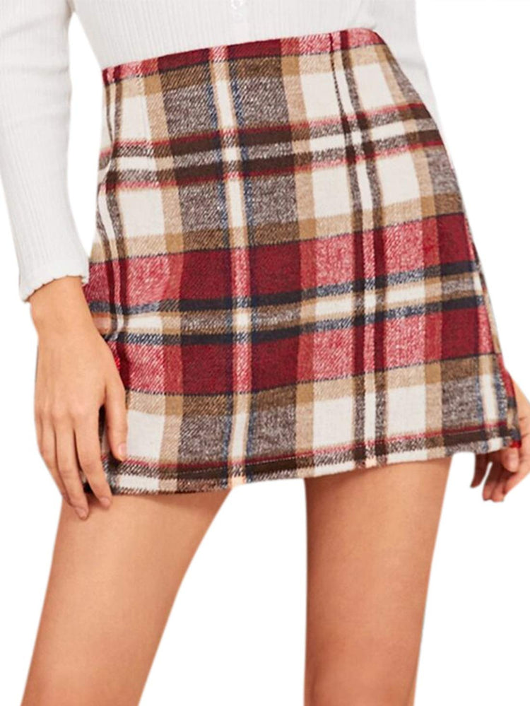 a woman wearing a plaid skirt