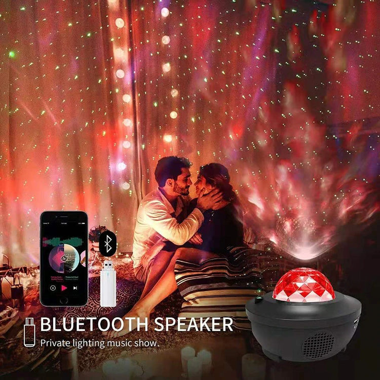 a man and woman kissing in a room with a bluetooth speaker