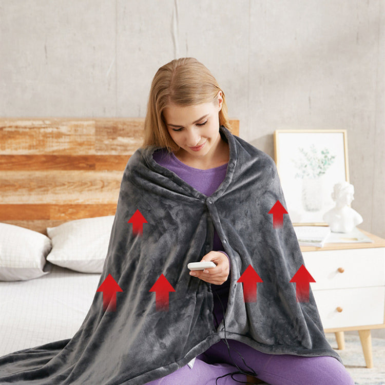 a woman sitting on a bed with a blanket on her head