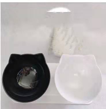 a cat shaped bowls on a white surface