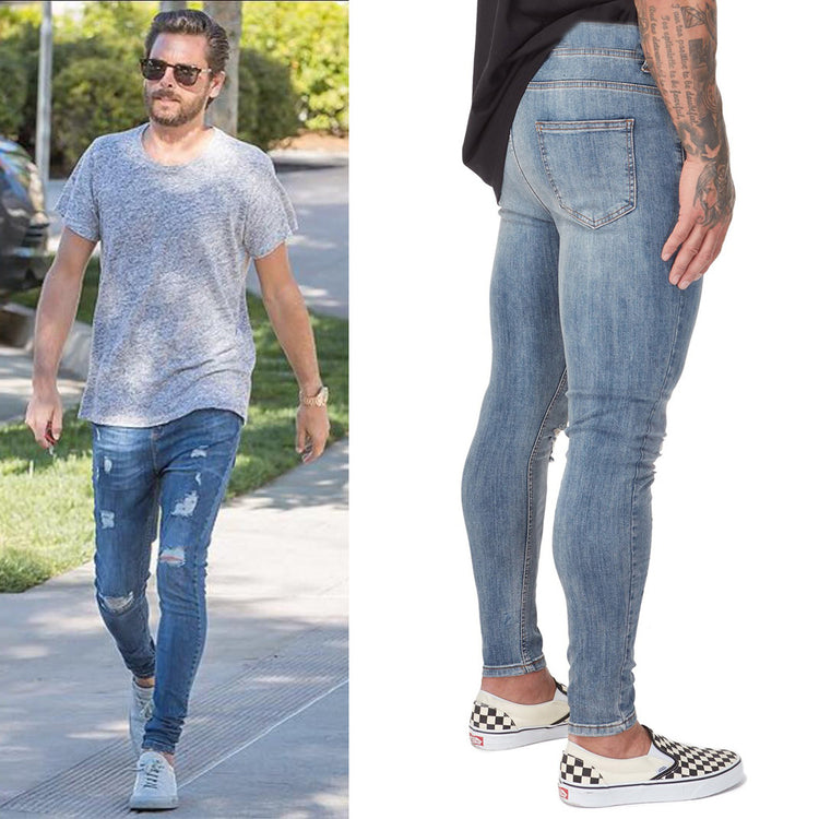 a man wearing jeans and a grey shirt