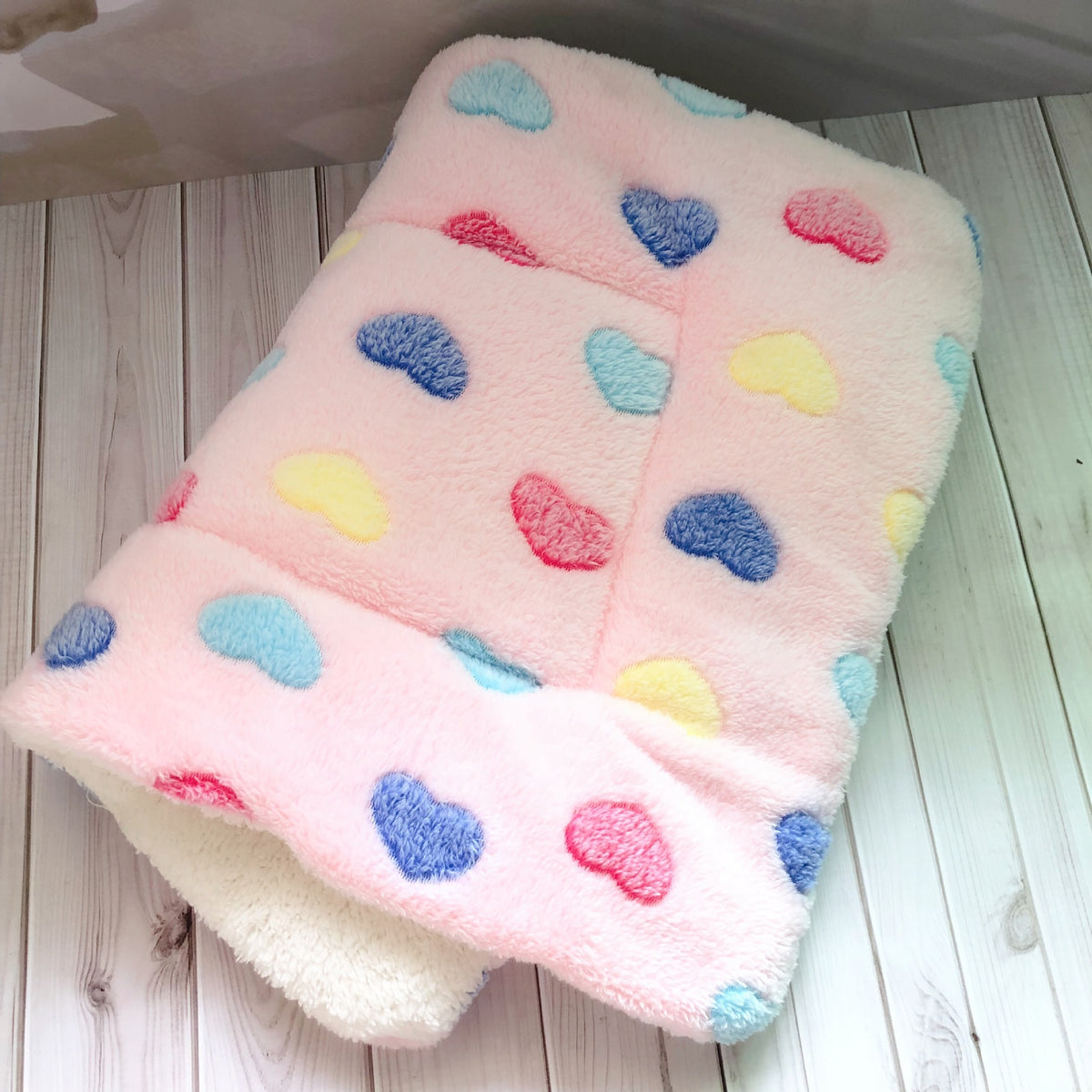 a pink blanket with hearts on it