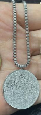 a hand holding a necklace