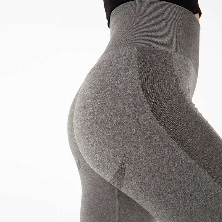 a woman wearing tight grey pants