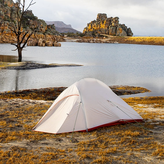 a tent next to a lake