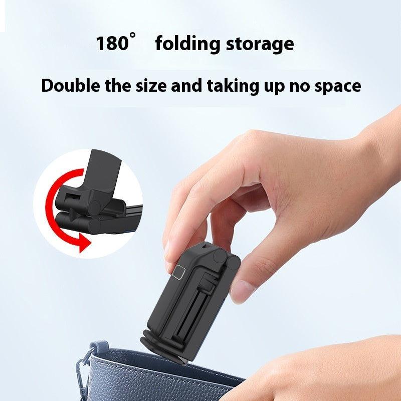 a hand holding a black object