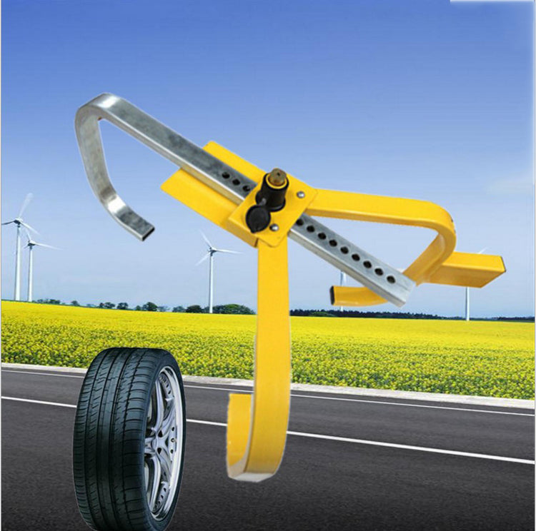 a yellow metal object with a wheel on the side of the road