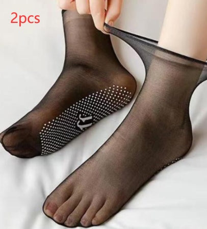 a person putting on a pair of black socks