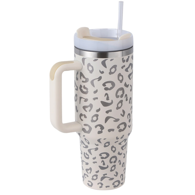 a white and grey leopard print travel mug with a straw