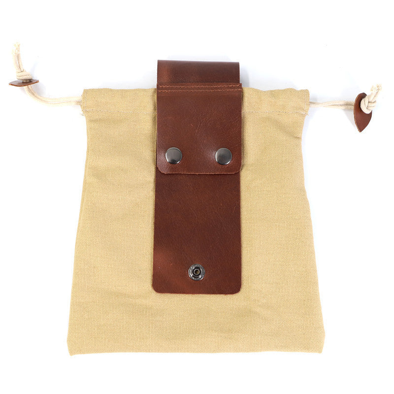a brown leather strap on a tan bag