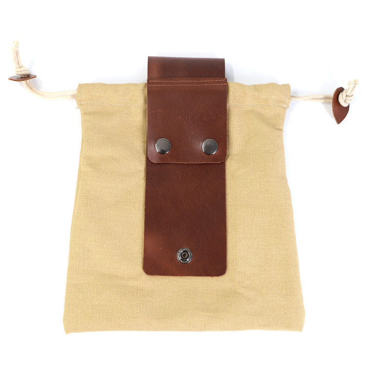 a brown leather strap on a tan bag